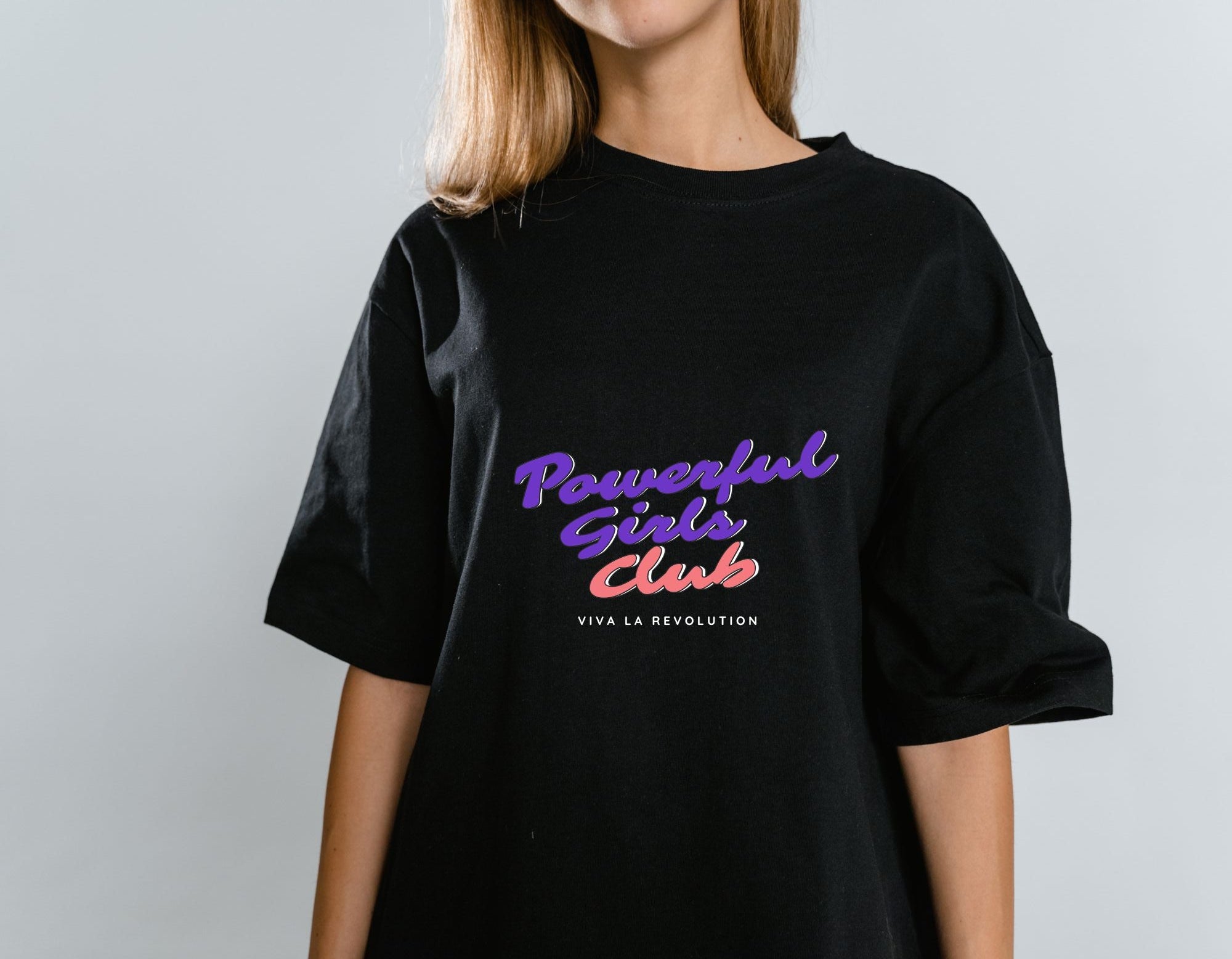 Women wearing black oversized t-shirt with text "Powerful Girls Club". Feminist apparel