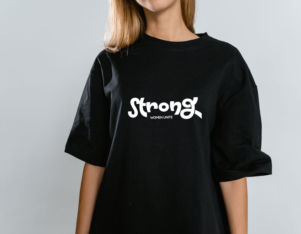 Women wearing black t-shirt with the wording "Strong Women Unite" . Feminist apparel